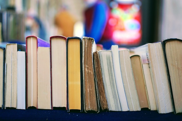 A row of books with a blurry background.
